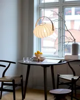DC Textile Pendel Satinhvid fra Halo Design over et spisebord ved vinduet - blødt lys ved bordet DC Textile Pendel Satinhvid fra Halo Design over et spisebord ved vinduet - blødt lys ved bordet